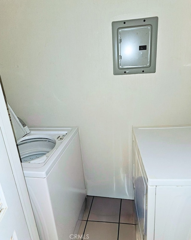 clothes washing area with washer and dryer and tile patterned floors