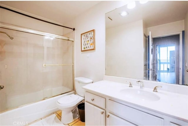 full bathroom with toilet, tile patterned flooring, vanity, and enclosed tub / shower combo