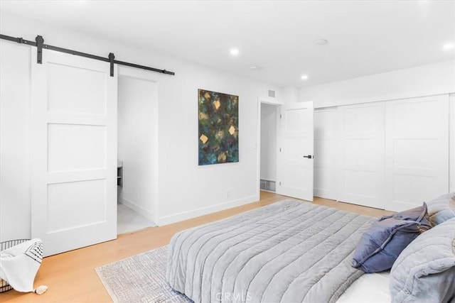 bedroom with a closet and a barn door