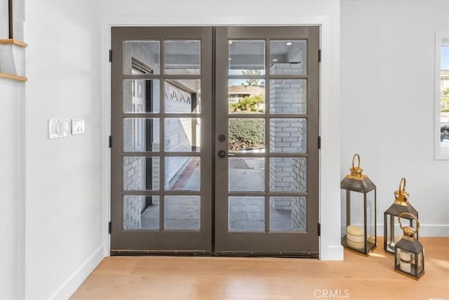 entryway with french doors and wood-type flooring