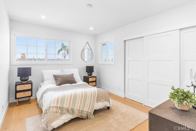 bedroom with a closet and light hardwood / wood-style flooring