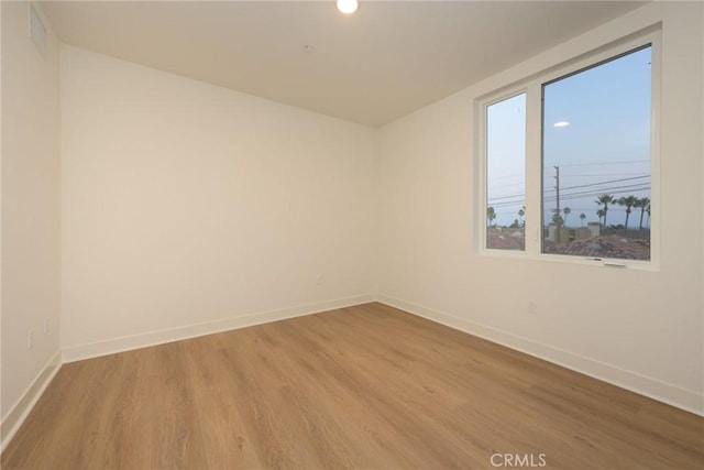 empty room with hardwood / wood-style floors