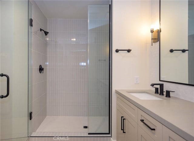 bathroom featuring an enclosed shower and vanity