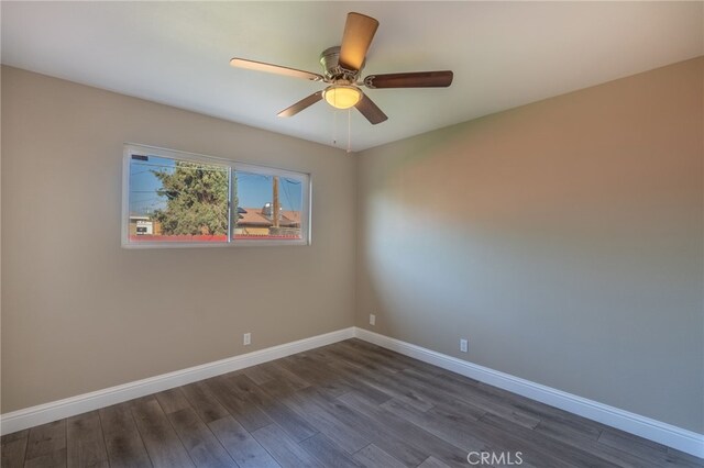 unfurnished room featuring ceiling fan and dark hardwood / wood-style flooring