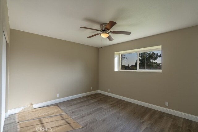 unfurnished room featuring ceiling fan and hardwood / wood-style floors