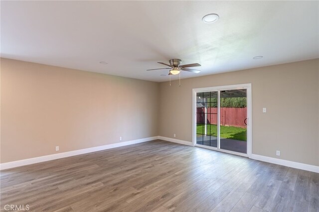 spare room with ceiling fan and wood-type flooring