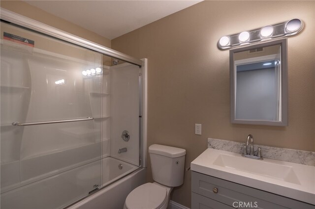 full bathroom featuring toilet, bath / shower combo with glass door, and vanity