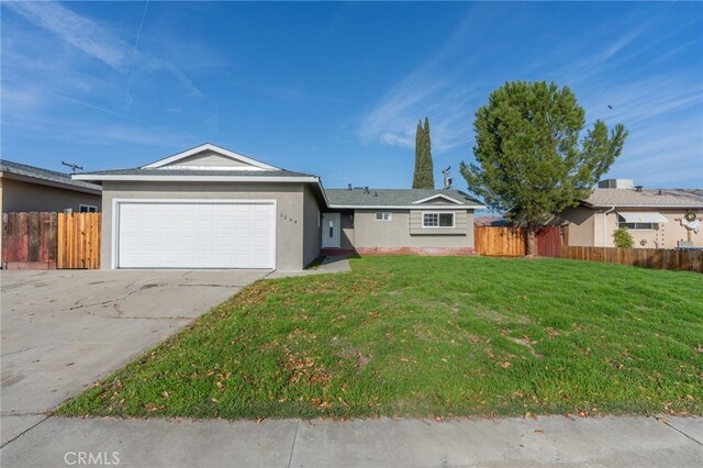 ranch-style house with a garage and a front lawn