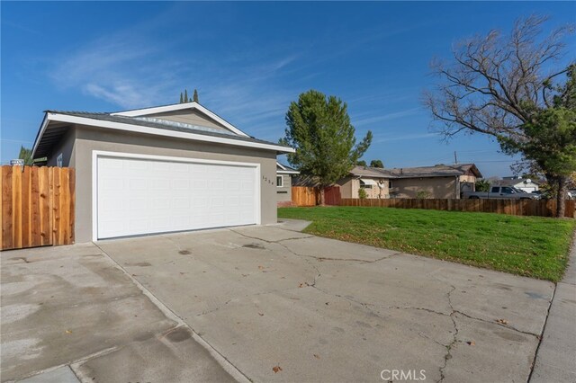 view of front of property with a front lawn and a garage