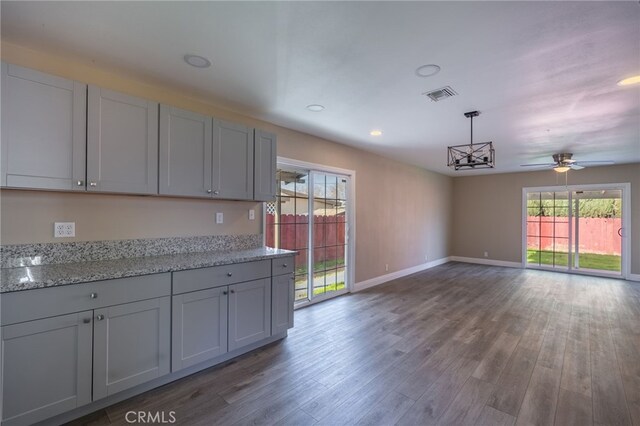 kitchen featuring decorative light fixtures, a wealth of natural light, gray cabinetry, and ceiling fan