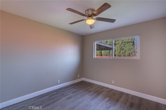 empty room with hardwood / wood-style flooring and ceiling fan