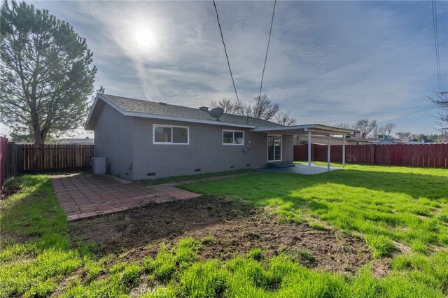 rear view of property with a yard and a patio