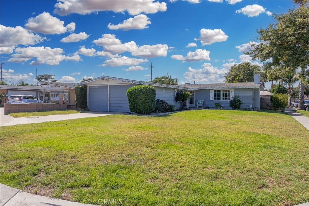 ranch-style home with a front yard and a garage