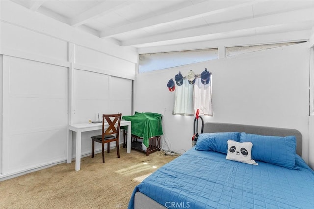 carpeted bedroom with beamed ceiling