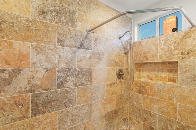 details with ornamental molding and a tile shower