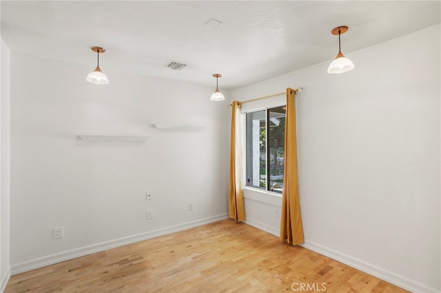 spare room featuring light hardwood / wood-style flooring