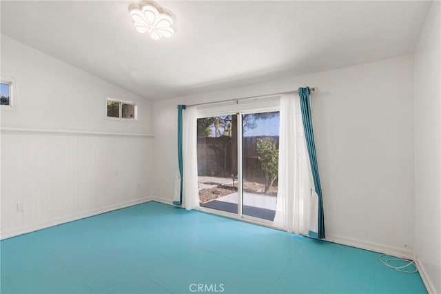 empty room featuring vaulted ceiling