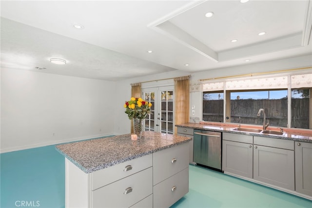 kitchen with dishwasher, gray cabinets, sink, a tray ceiling, and french doors