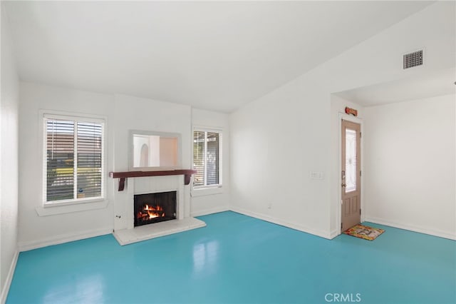 unfurnished living room with a fireplace and vaulted ceiling