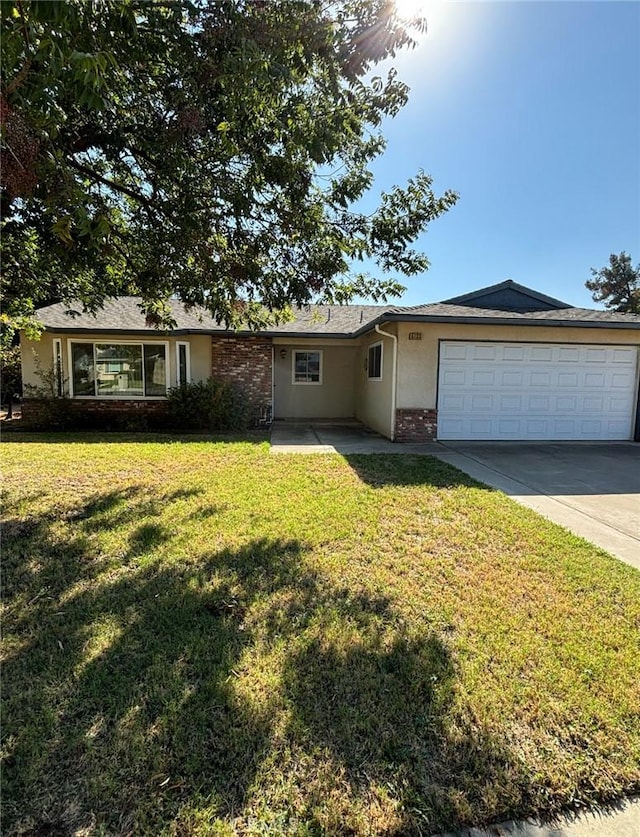 ranch-style house featuring a garage and a front lawn