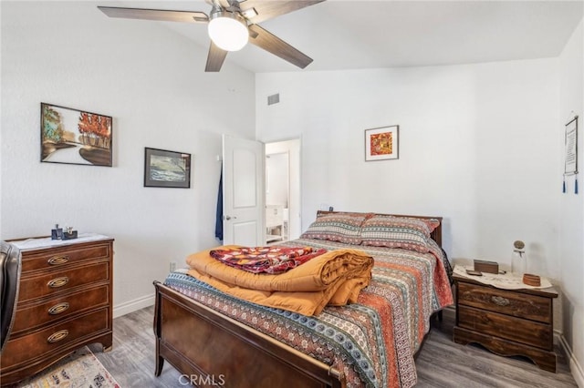 bedroom with ceiling fan, lofted ceiling, and wood-type flooring