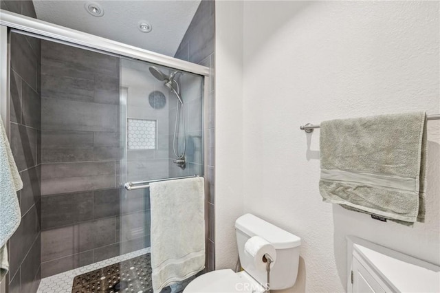 bathroom with walk in shower and toilet