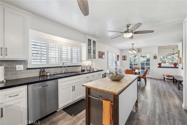 kitchen with dishwasher, sink, a wealth of natural light, and white cabinets