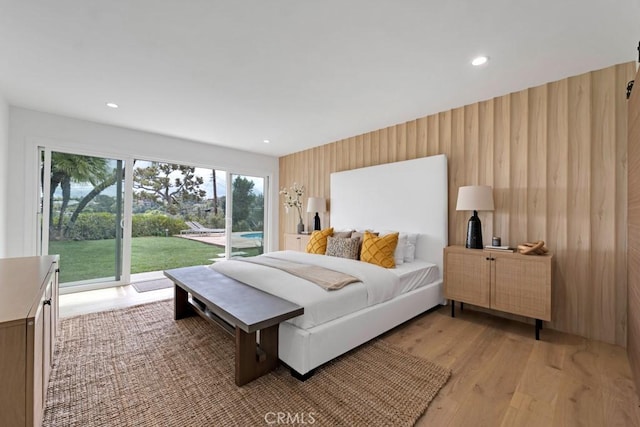 bedroom featuring access to exterior and light hardwood / wood-style flooring