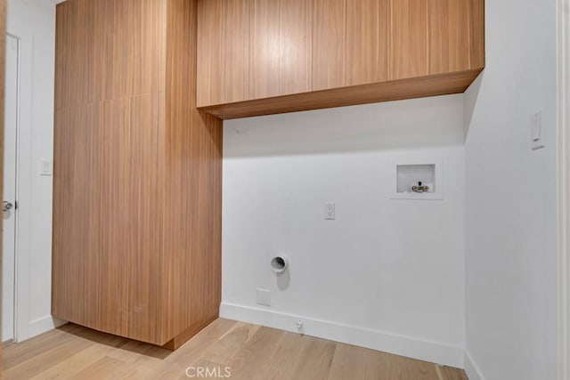 laundry room featuring electric dryer hookup, light hardwood / wood-style flooring, and hookup for a washing machine