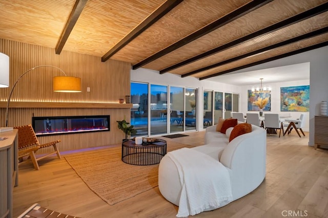 living room featuring wood-type flooring, a large fireplace, wood walls, lofted ceiling with beams, and wooden ceiling