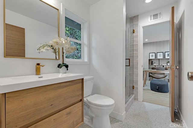 bathroom featuring toilet, walk in shower, and vanity