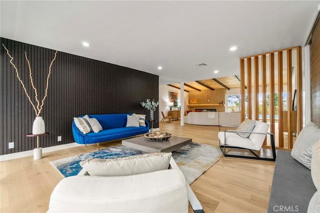 living room featuring hardwood / wood-style floors and beam ceiling