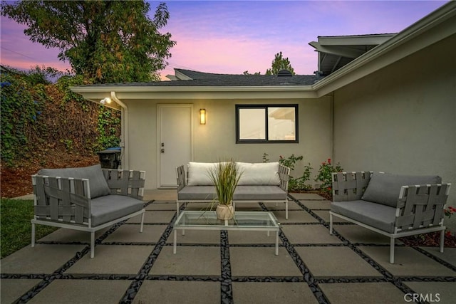 patio terrace at dusk featuring outdoor lounge area