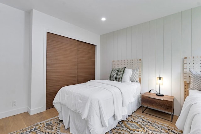 bedroom with a closet and light hardwood / wood-style floors