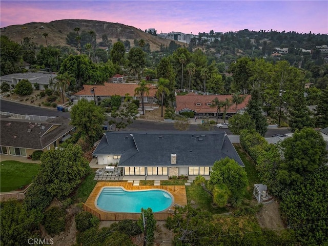 aerial view at dusk featuring a mountain view