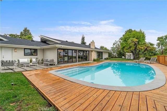 view of pool with an outdoor hangout area and a deck