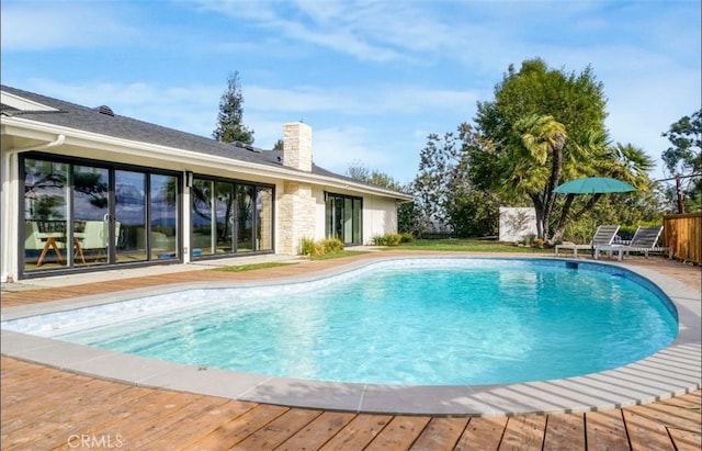 view of swimming pool featuring a deck