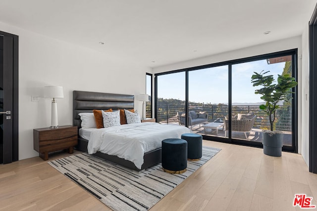 bedroom featuring access to outside and light hardwood / wood-style floors