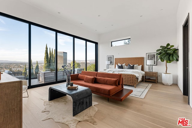 bedroom with light wood-type flooring and access to outside