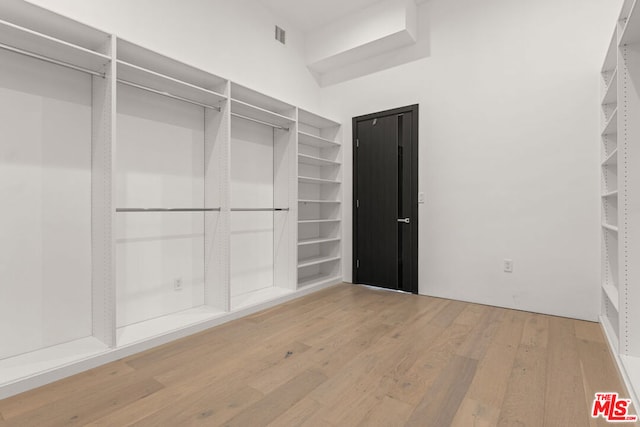 walk in closet featuring hardwood / wood-style flooring