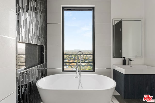 bathroom with a bathtub and vanity