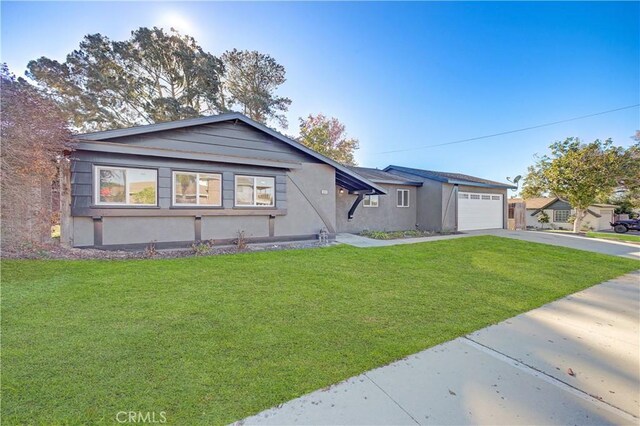 ranch-style home featuring a front lawn and a garage