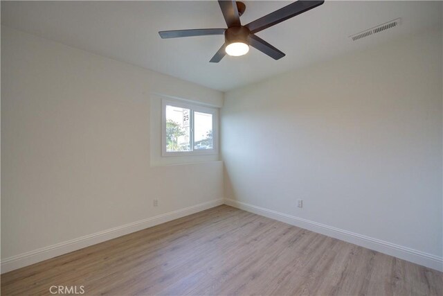 spare room featuring ceiling fan and light wood-type flooring