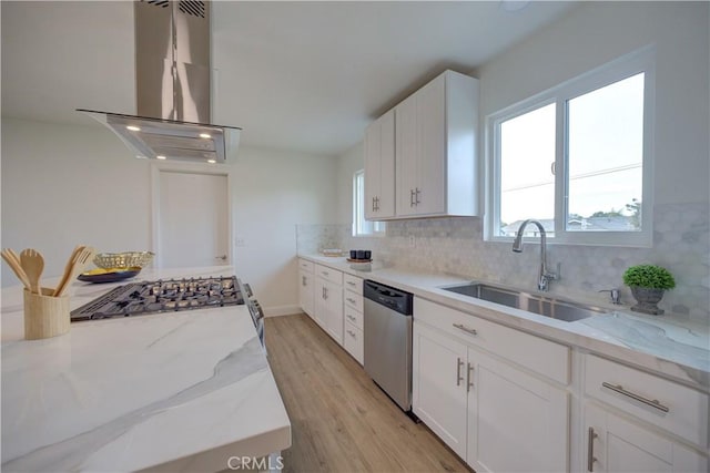 kitchen with sink, white cabinetry, ventilation hood, stainless steel dishwasher, and light stone countertops