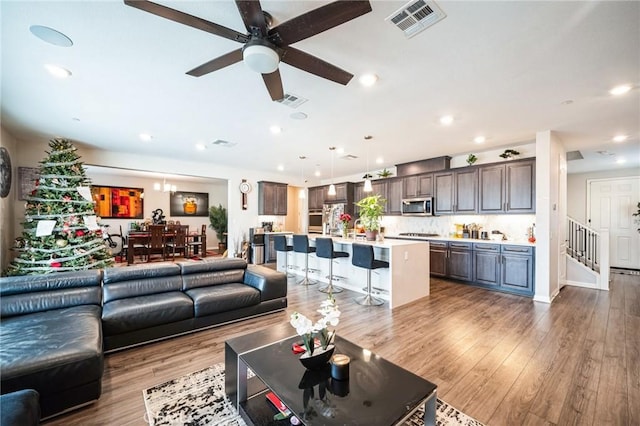 living room featuring ceiling fan and hardwood / wood-style flooring