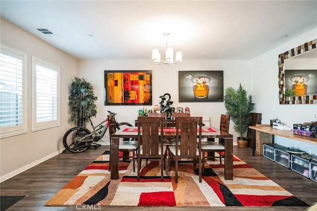 dining room featuring dark wood-type flooring and a chandelier