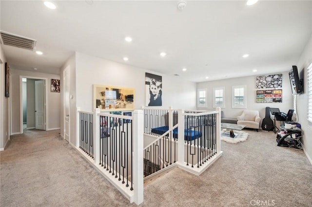 hall featuring light colored carpet