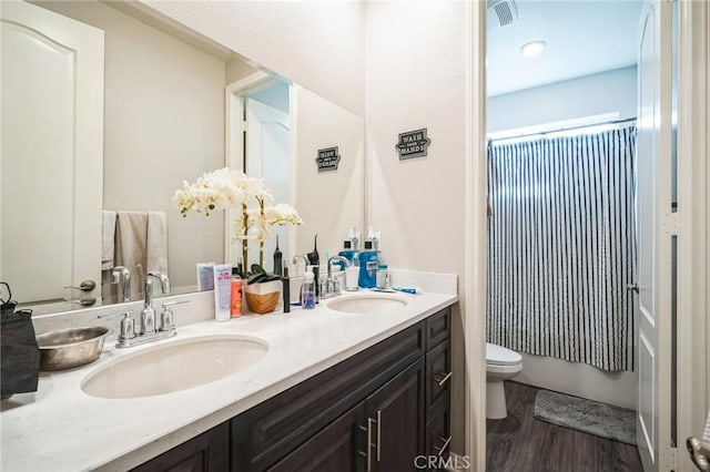 full bathroom with toilet, vanity, wood-type flooring, and shower / bath combo with shower curtain