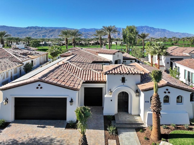 mediterranean / spanish home with a mountain view and a garage