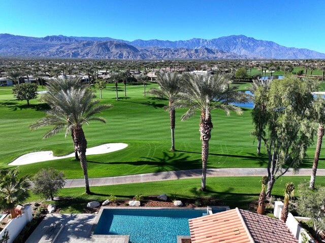 exterior space with a mountain view and a lawn